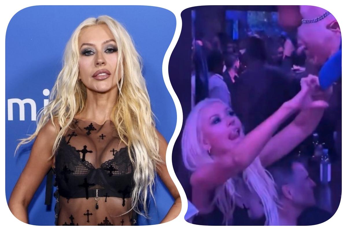 De sutiã à mostra, Christina Aguilera se diverte e 'paparica' gogoboy em evento